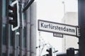 StraÃÅ¸enschild: "Kurfuerstendamm" in Berllin; geringe TiefenschÃÂ¤rfe; Nebel; Ampel Royalty Free Stock Photo